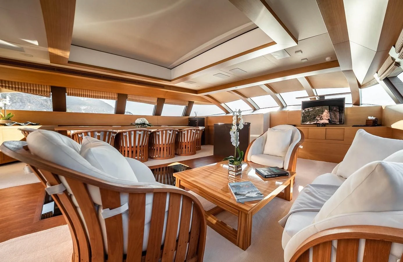 a room with a table and chairs aboard QHT Yacht for Sale