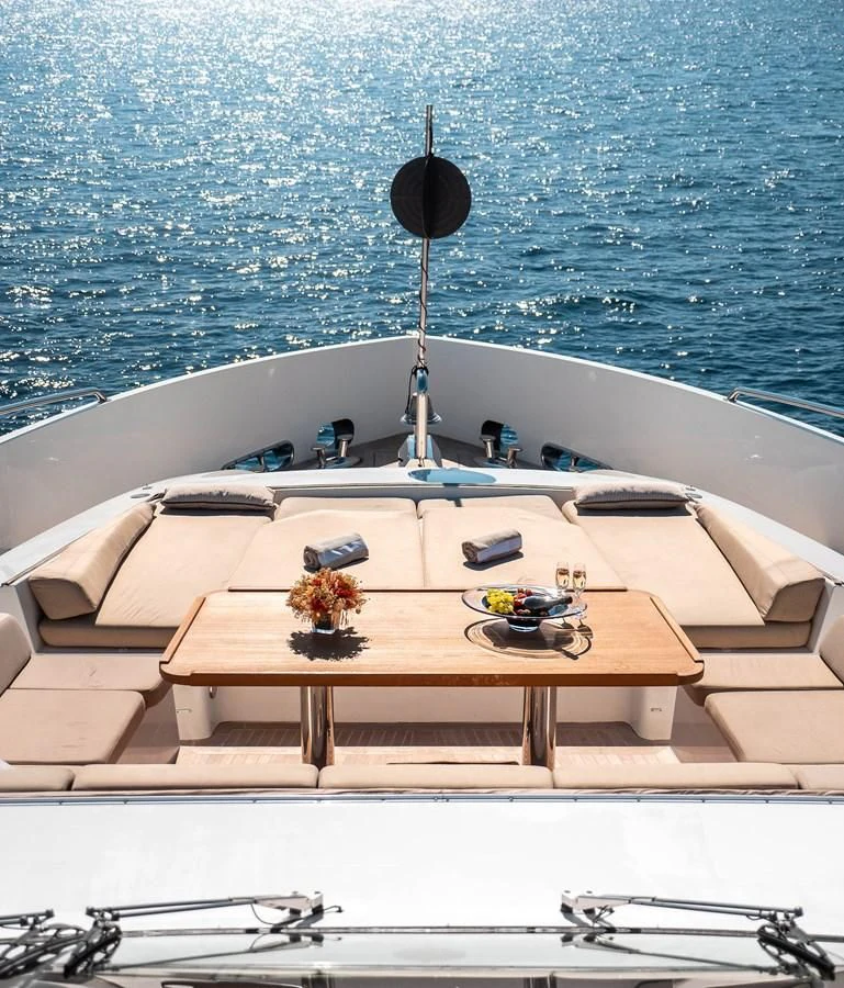 a boat with a table and chairs aboard QHT Yacht for Sale