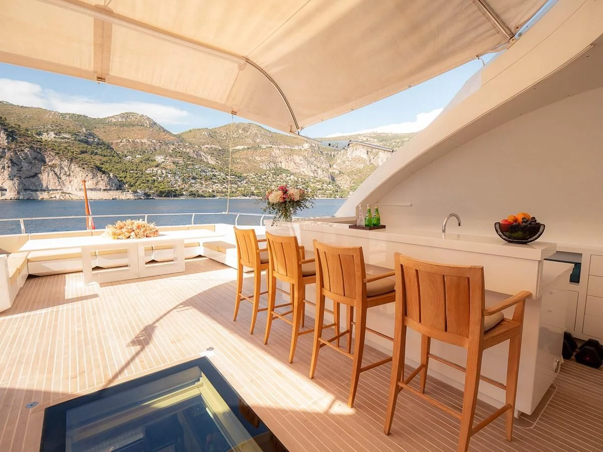 a room with a table and chairs aboard QHT Yacht for Sale