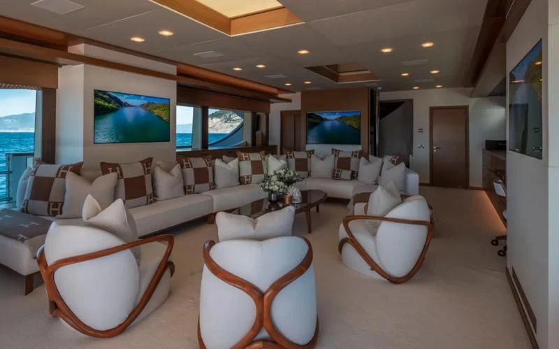 a living room with a large screen aboard QHT Yacht for Sale