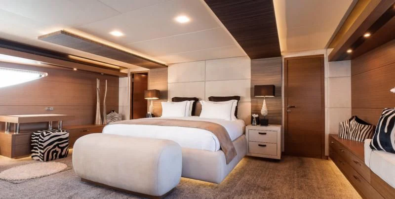 a large bedroom with a large bed aboard QHT Yacht for Sale