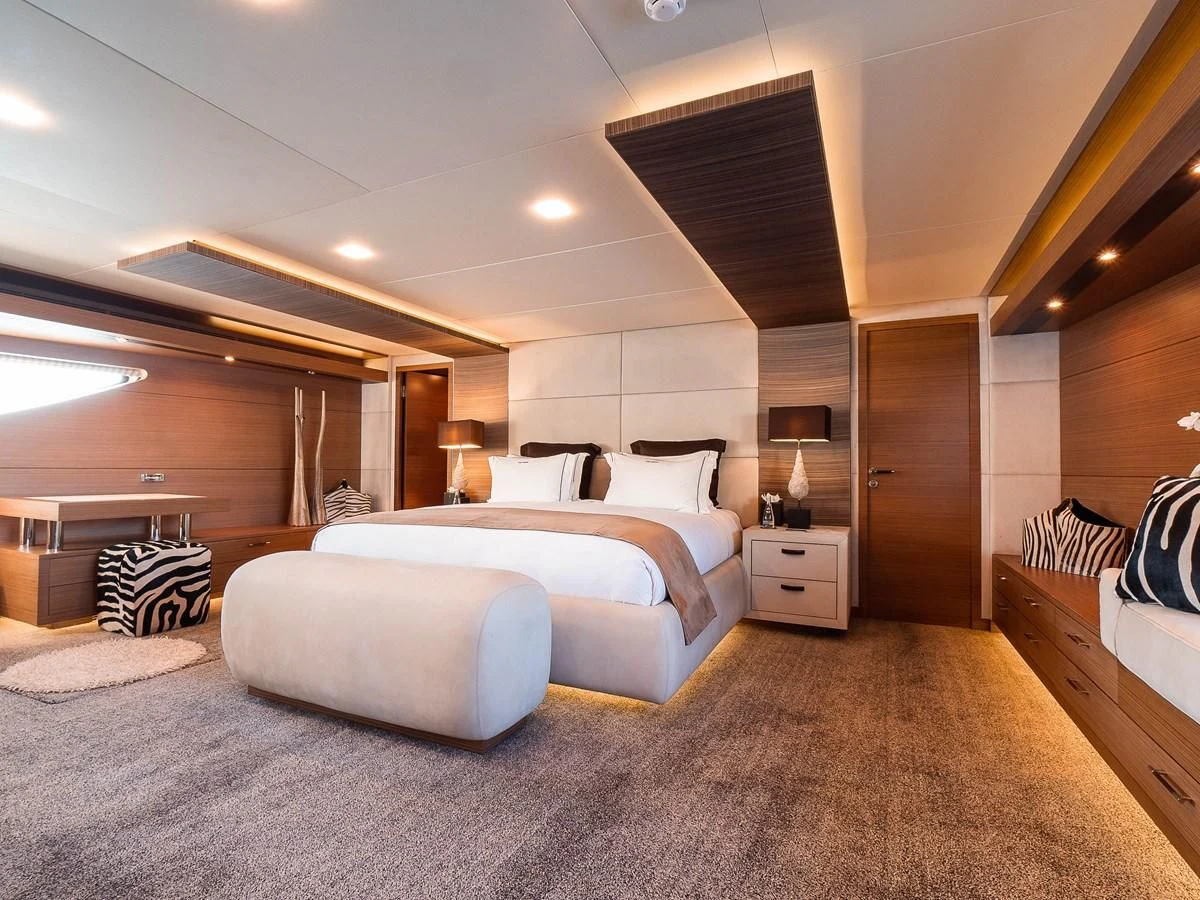 a large bedroom with a large bed aboard QHT Yacht for Sale