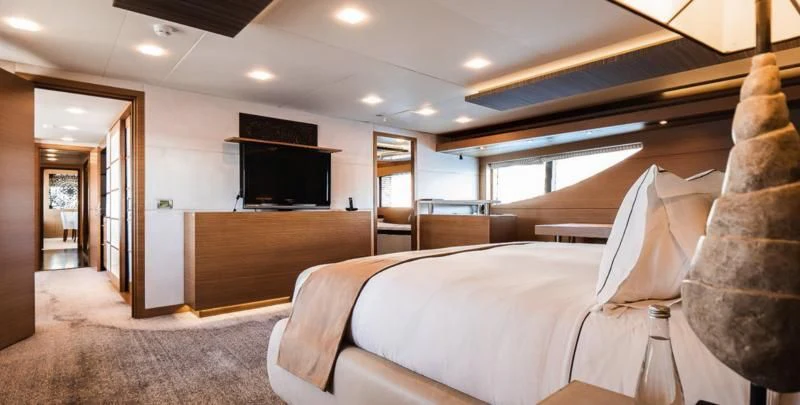 a hotel room with a bed and a tv aboard QHT Yacht for Sale