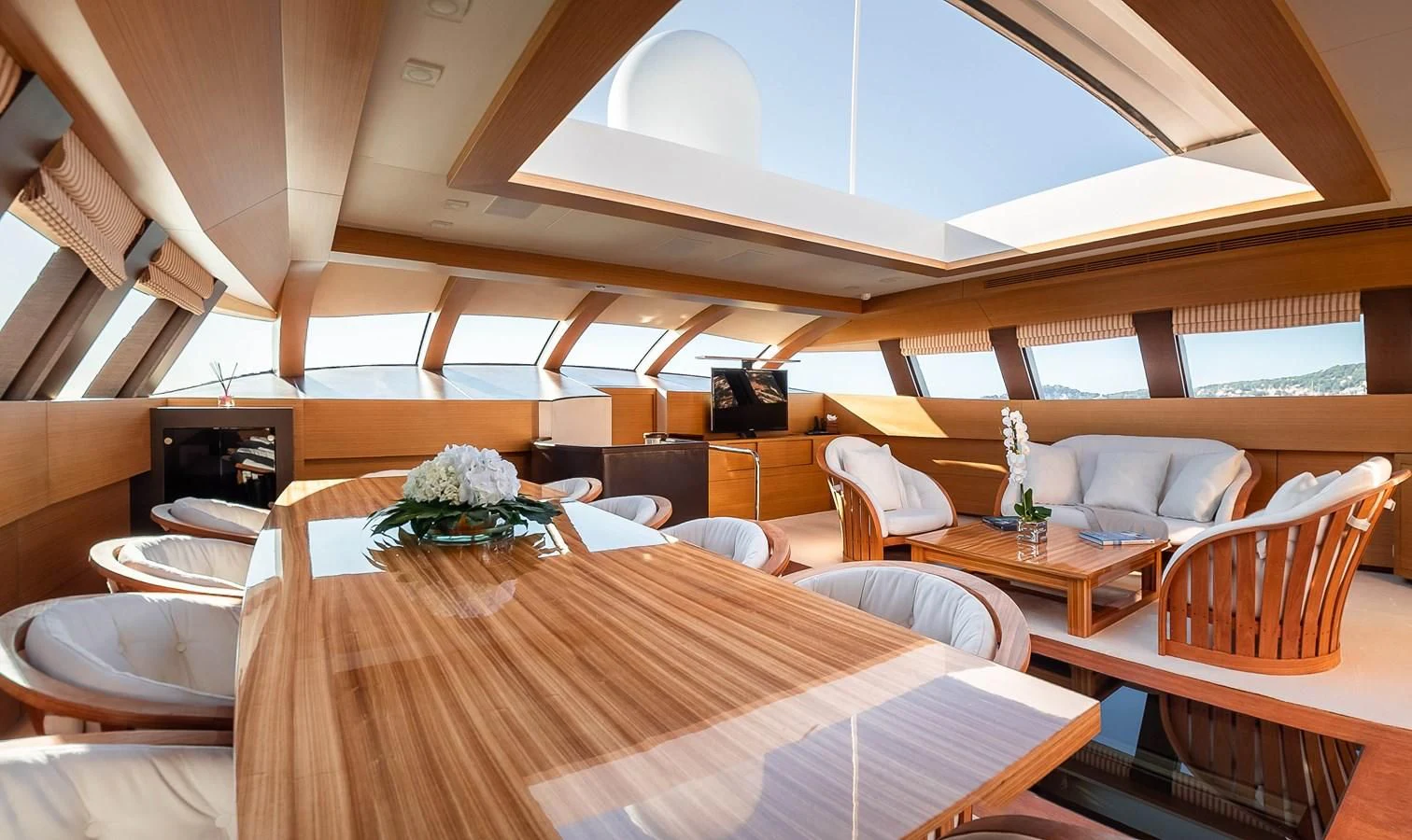a room with a table and chairs aboard QHT Yacht for Sale