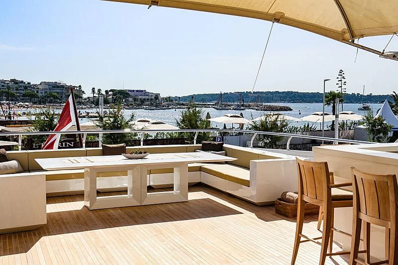 a patio with a view of a city and water aboard QHT Yacht for Sale