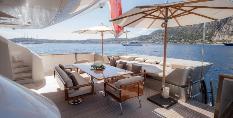 a table and chairs on a boat aboard QHT Yacht for Sale