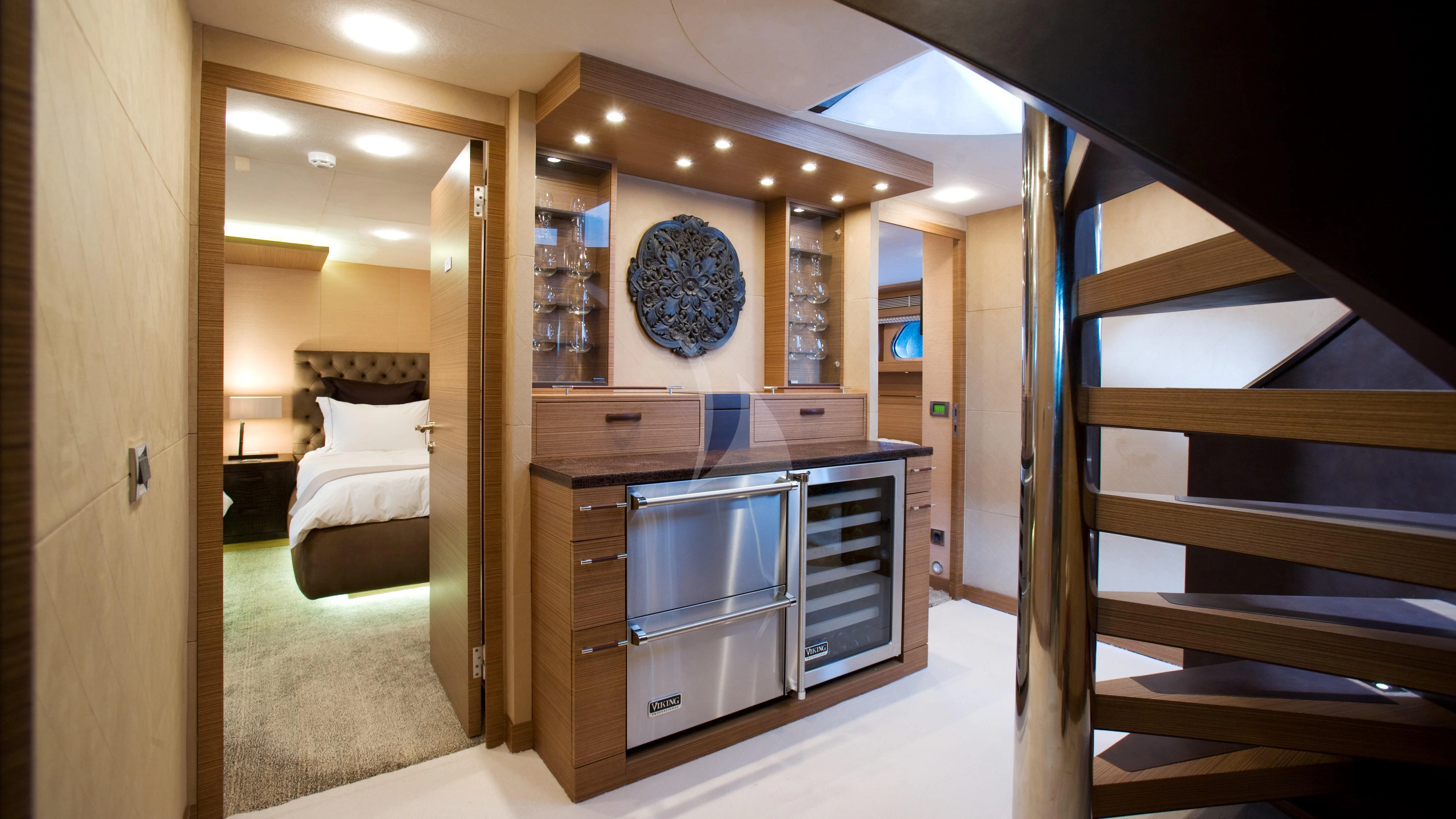 a room with a bed and a desk aboard QHT Yacht for Sale