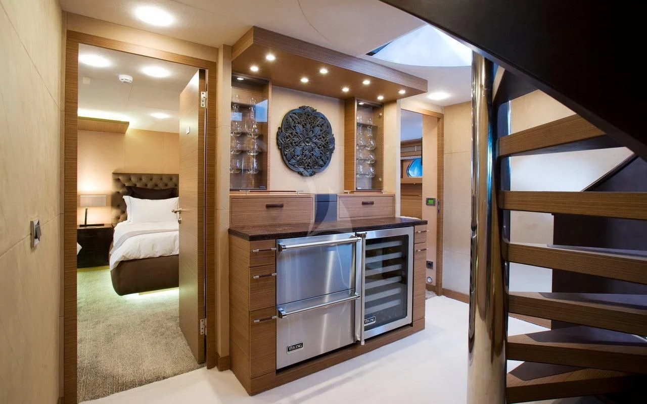 a bedroom with a bed and a desk aboard QHT Yacht for Sale