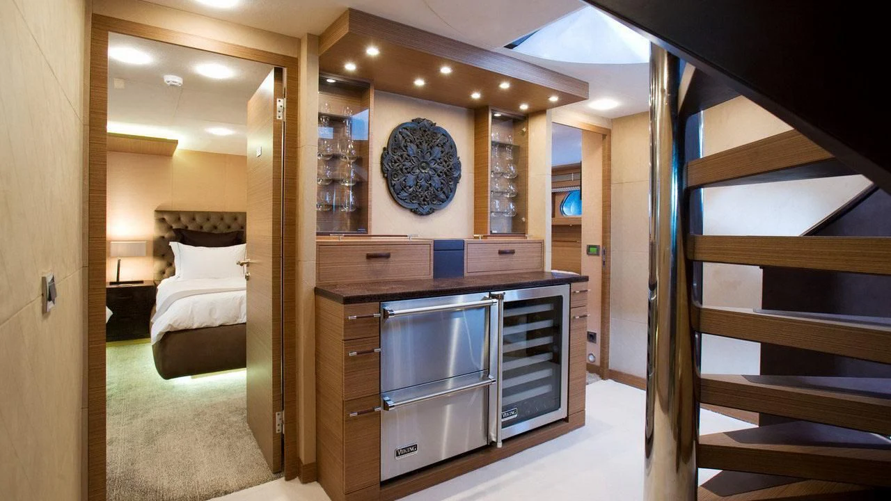 a room with a bed and a fireplace aboard QHT Yacht for Sale