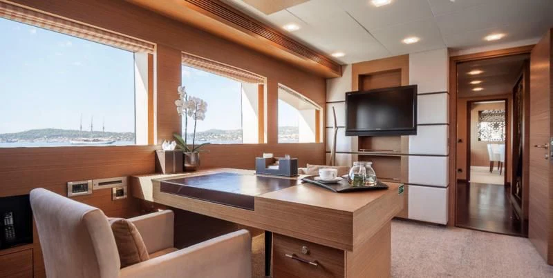a room with a tv and a couch aboard QHT Yacht for Sale