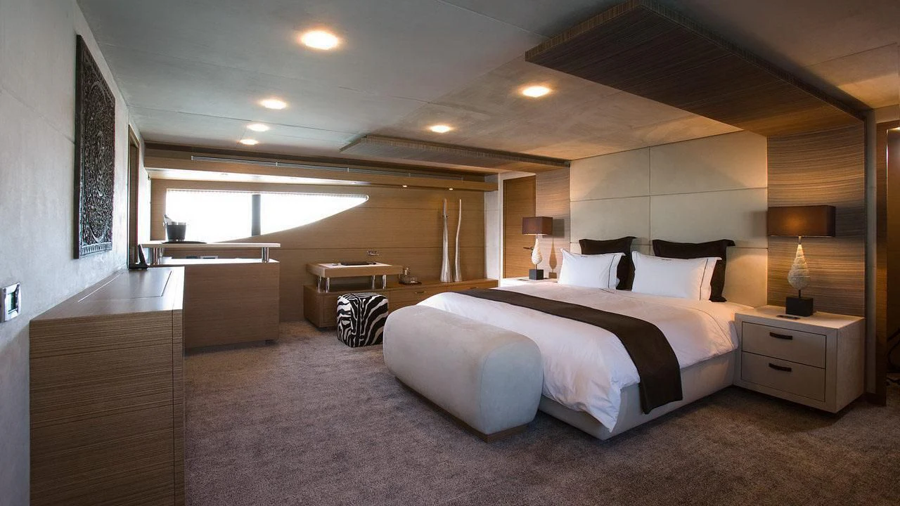 a large bedroom with a large bed aboard QHT Yacht for Sale