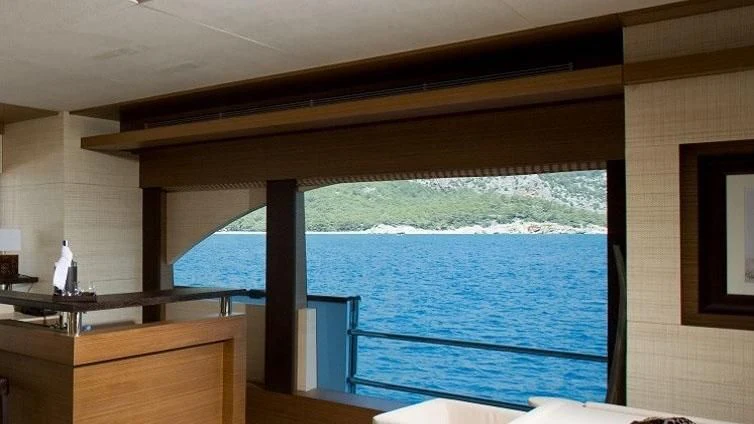 a room with a view of the ocean and a large window aboard QHT Yacht for Sale