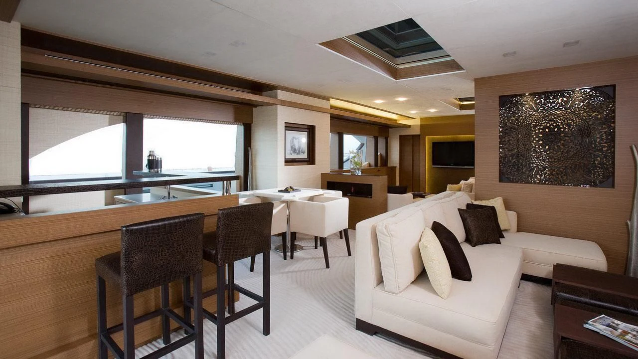 a room with a couch and a table and chairs aboard QHT Yacht for Sale