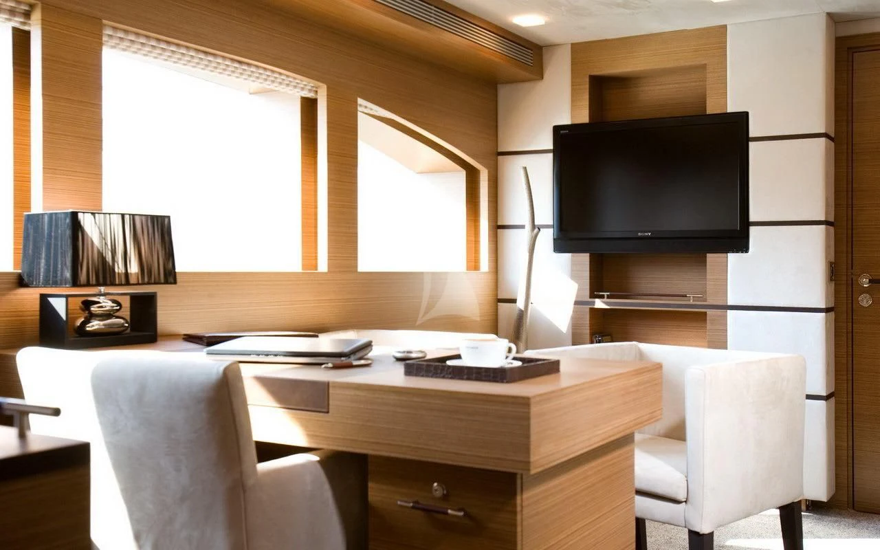 a room with a tv and a table aboard QHT Yacht for Sale