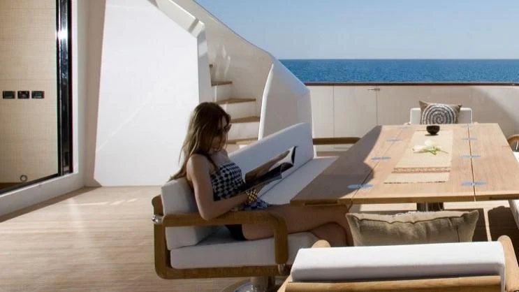 a person sitting at a desk aboard QHT Yacht for Sale