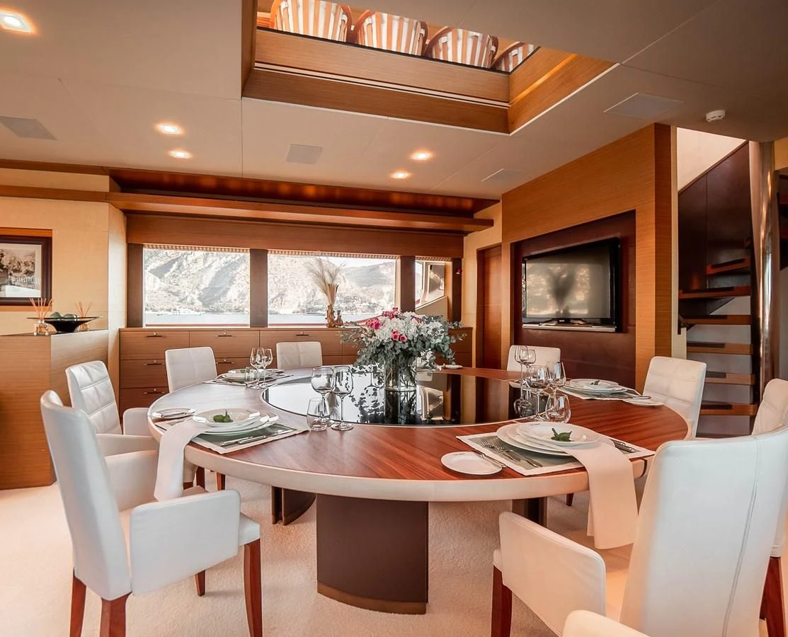 a dining room with a table and chairs aboard QHT Yacht for Sale