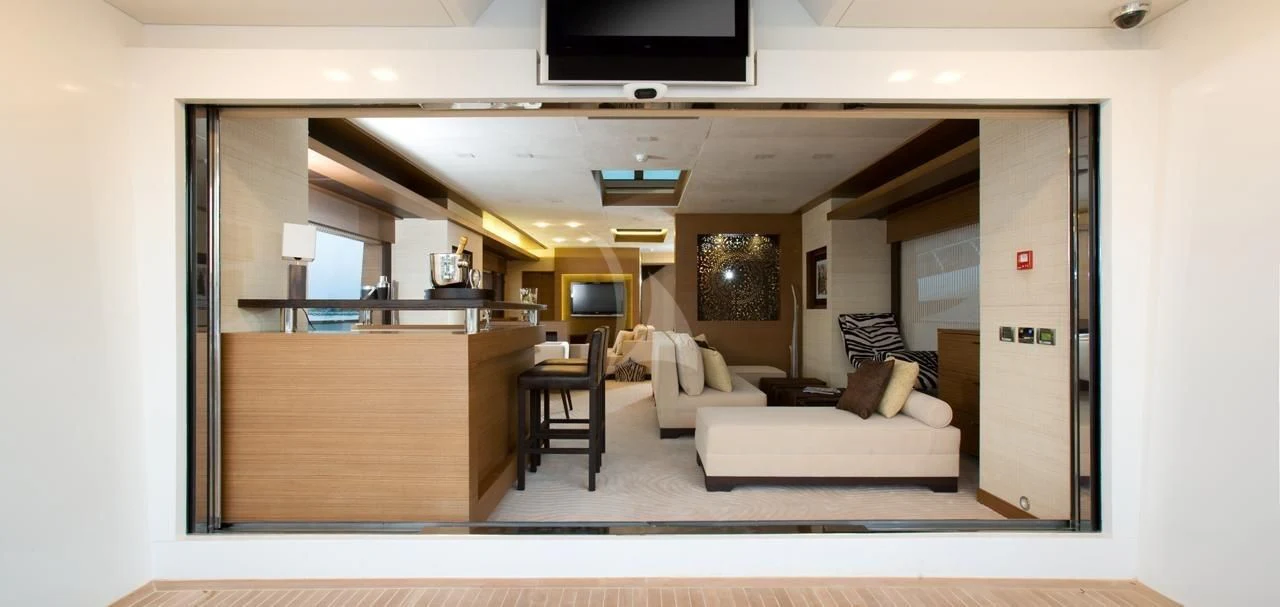 a room with a couch and a tv aboard QHT Yacht for Sale