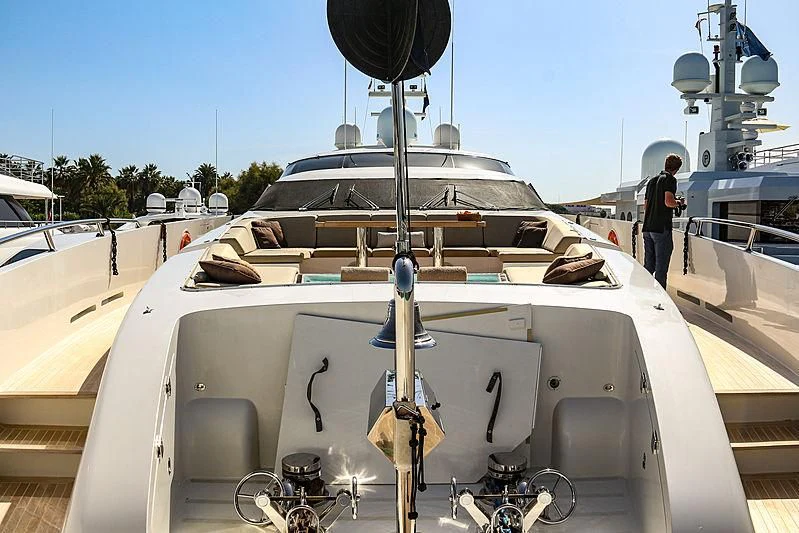 a boat with a person standing on the deck aboard QHT Yacht for Sale