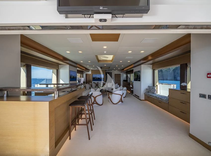 a room with tables and chairs aboard QHT Yacht for Sale