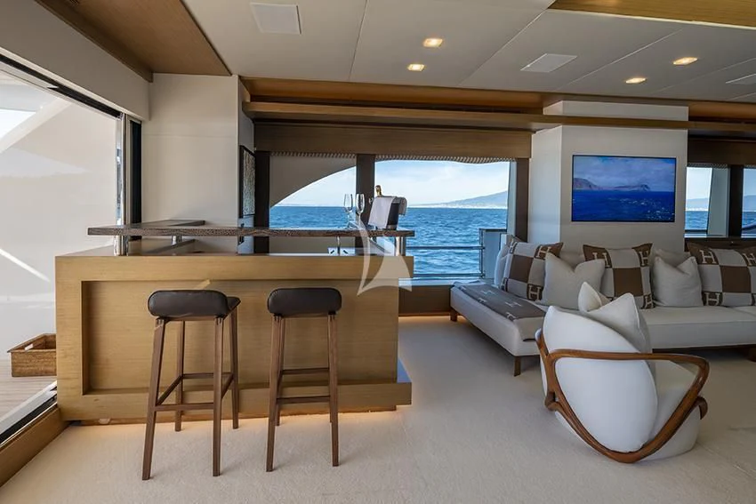 a room with a couch and a table and chairs aboard QHT Yacht for Sale