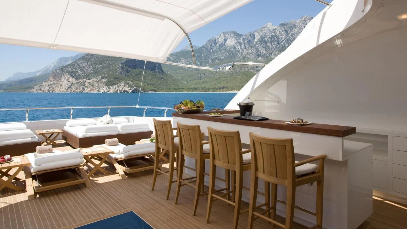 a room with a table and chairs aboard QHT Yacht for Sale