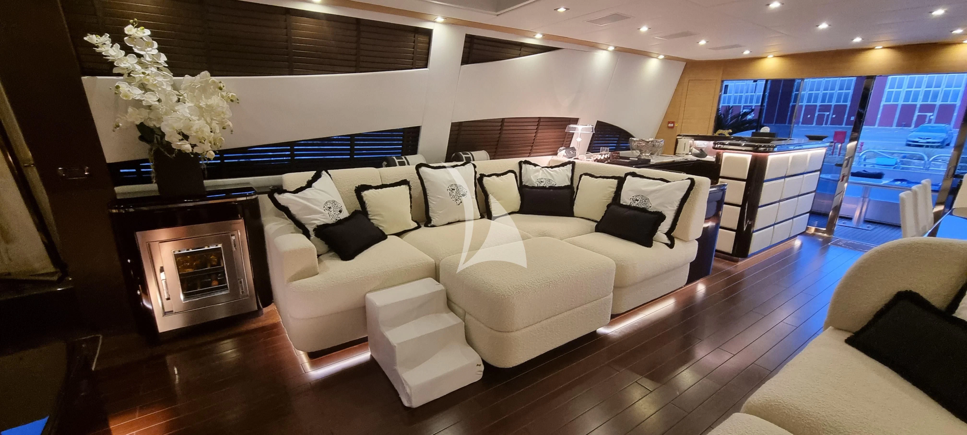 a living room with a couch and a fireplace aboard MANU V Yacht for Sale