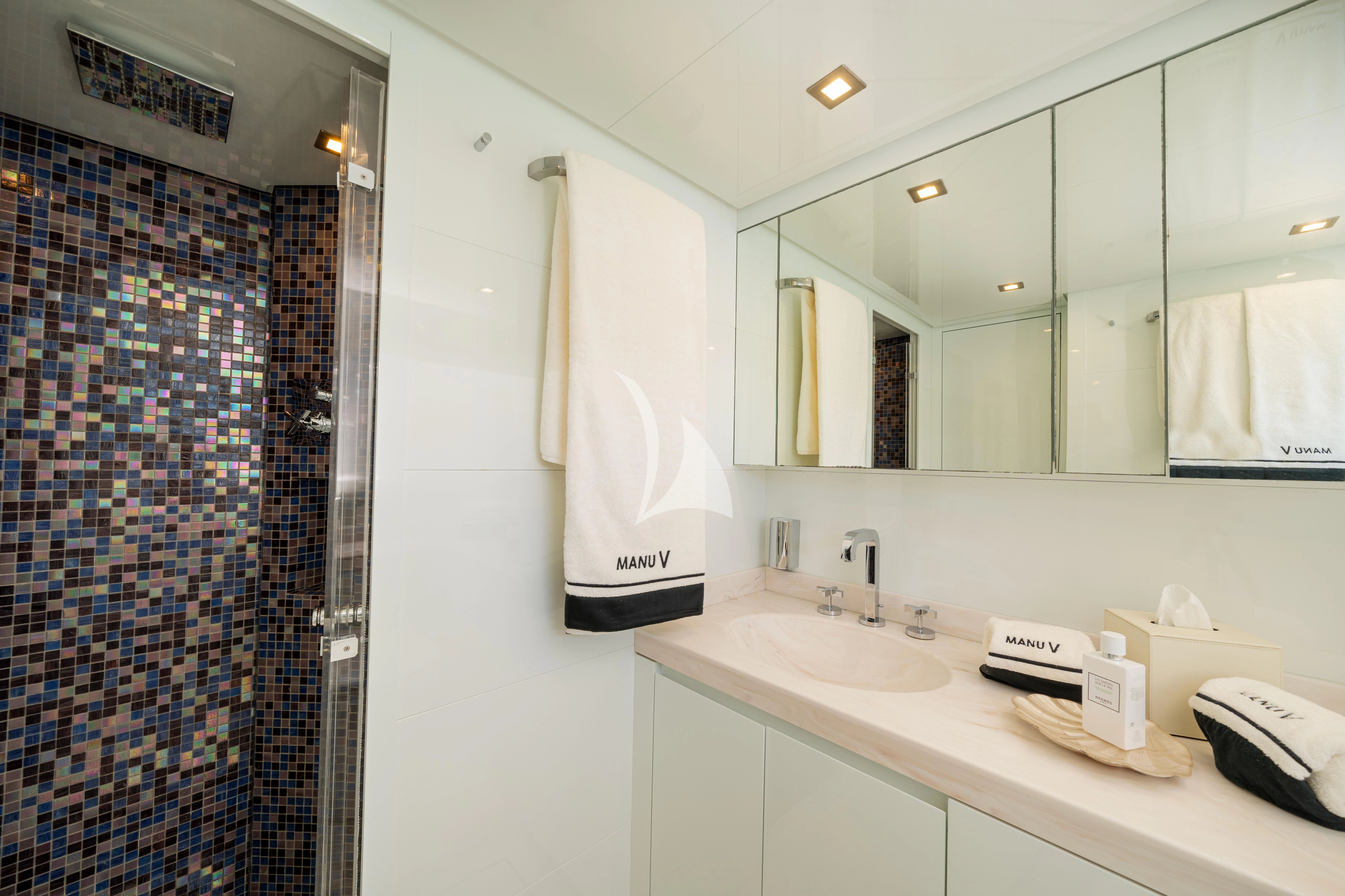 a bathroom with a sink and a mirror aboard MANU V Yacht for Sale
