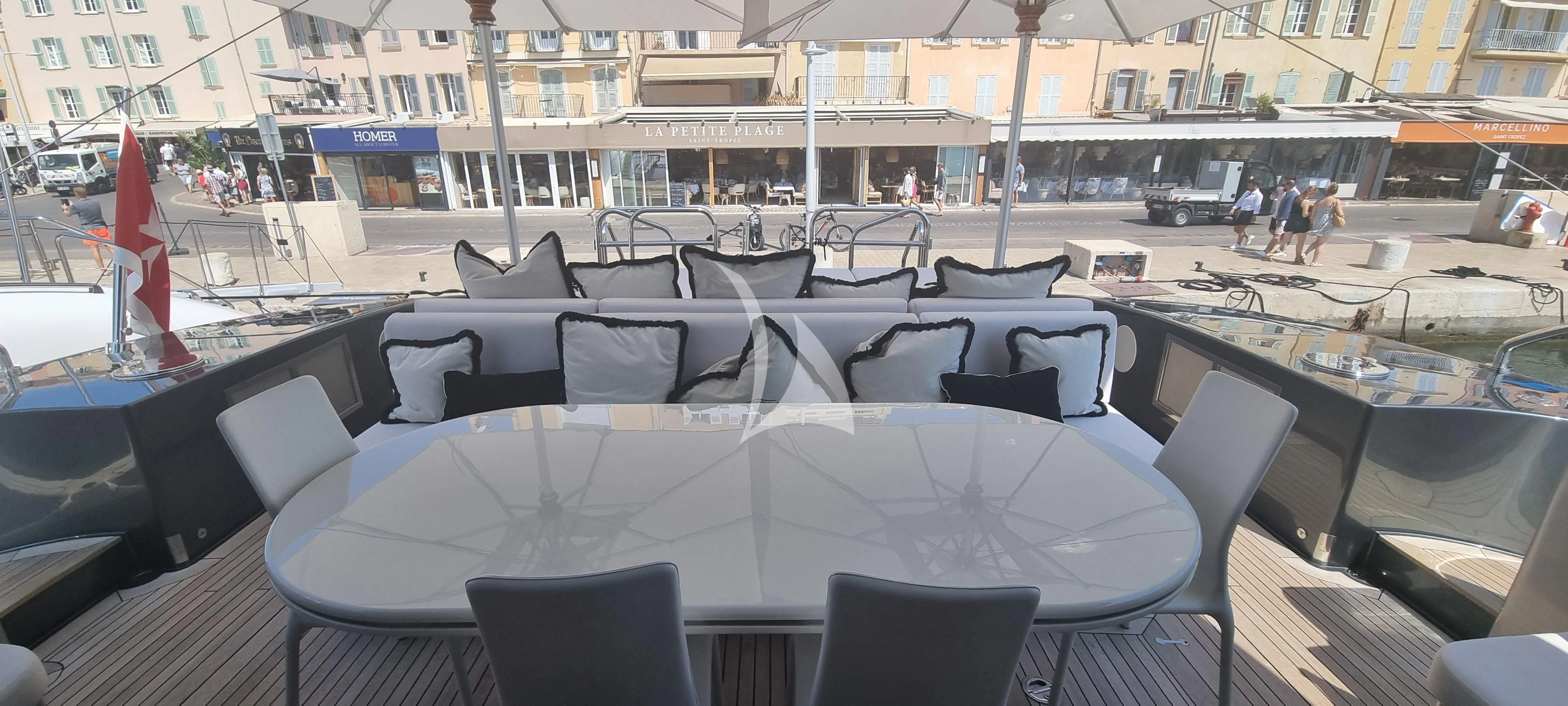 a table with chairs on it aboard MANU V Yacht for Sale