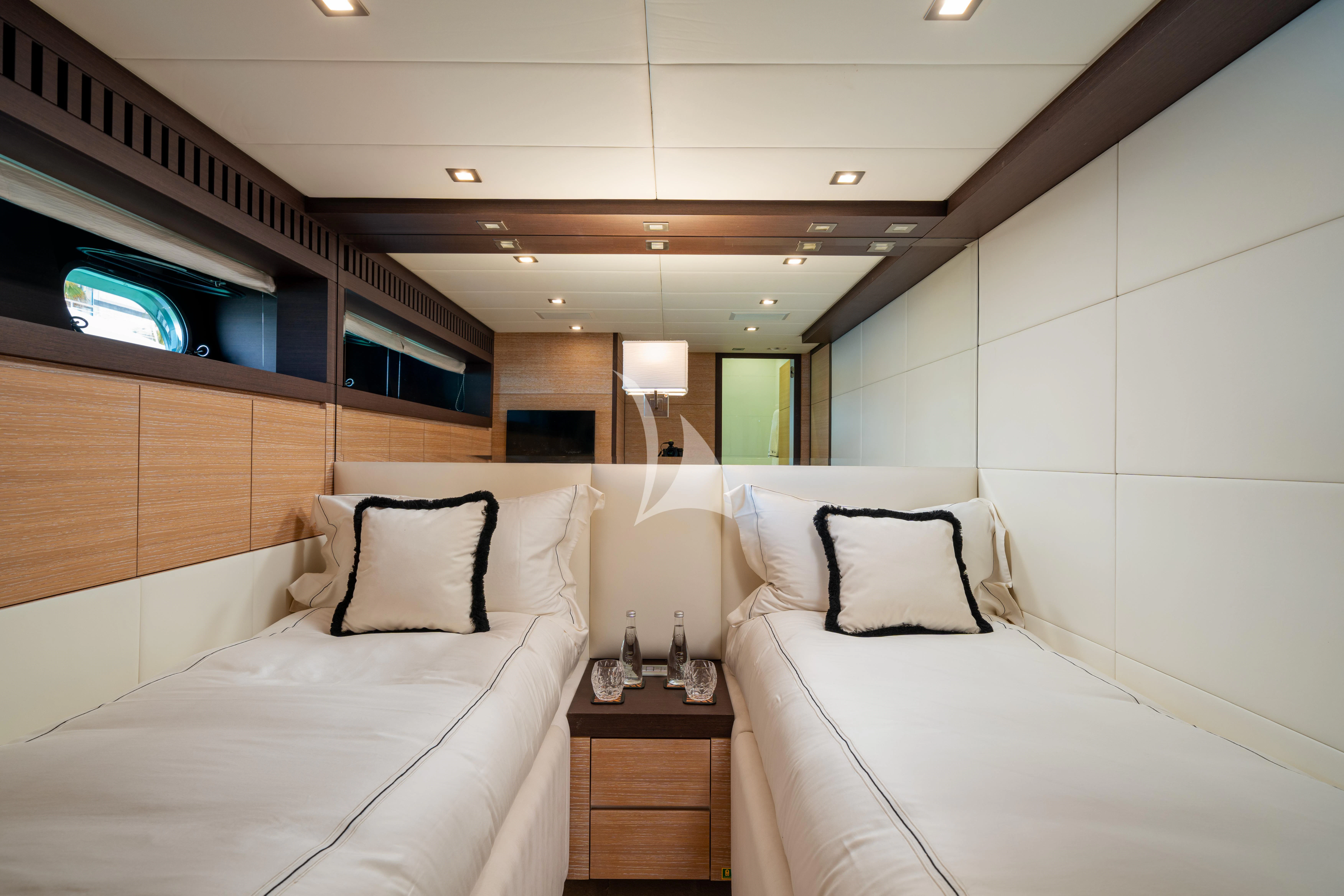 a room with two beds aboard MANU V Yacht for Sale