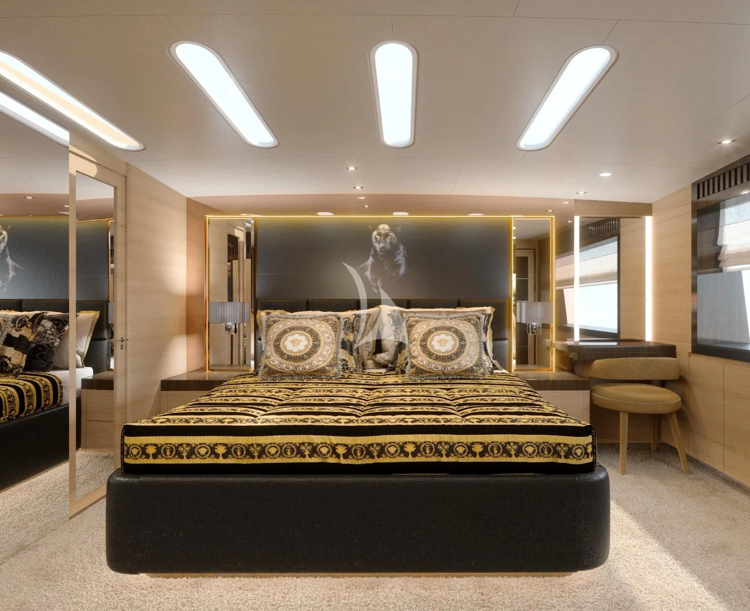 a large black bed with gold and black covers in a room with a large mirror and a white aboard MANU V Yacht for Sale