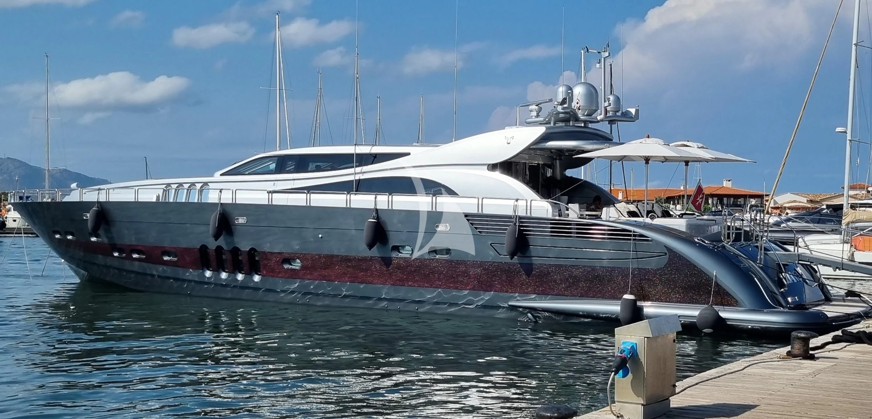 a boat docked at a pier aboard MANU V Yacht for Sale