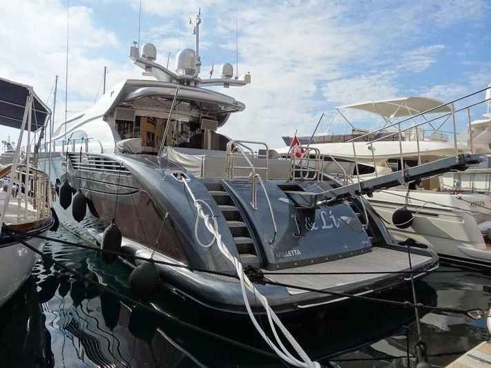 a boat docked at a pier aboard MANU V Yacht for Sale