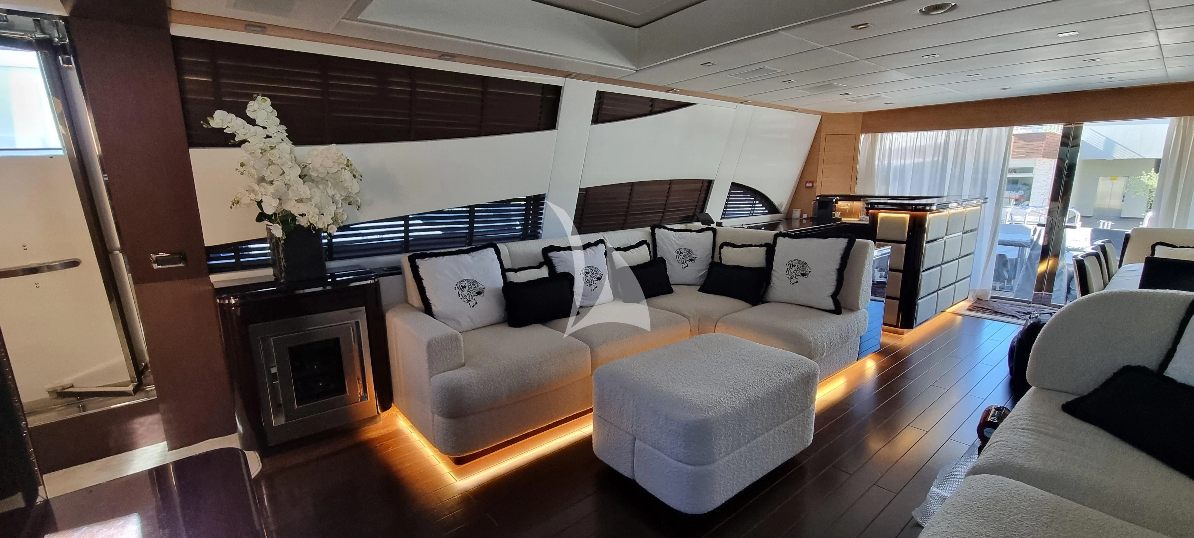 a living room with a fireplace aboard MANU V Yacht for Sale