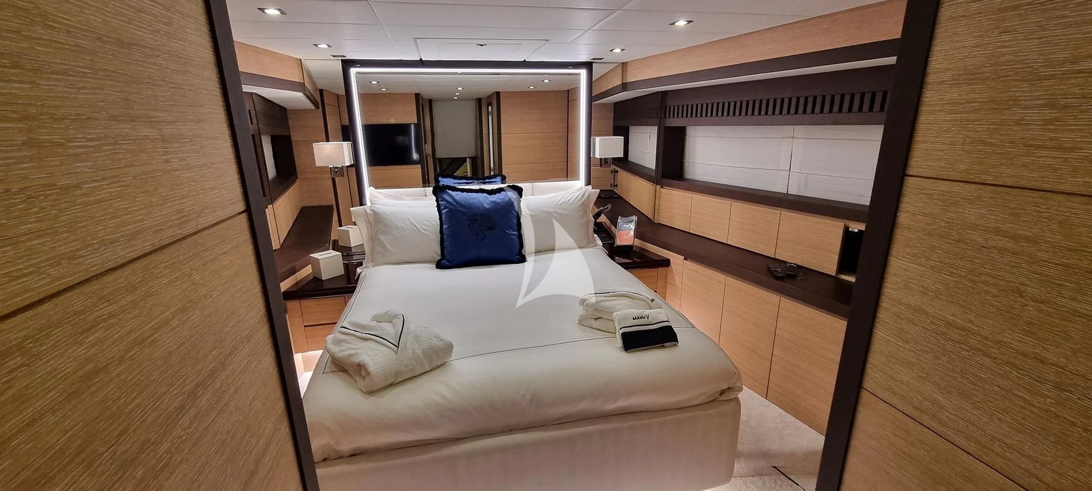a room with a bed and a desk aboard MANU V Yacht for Sale