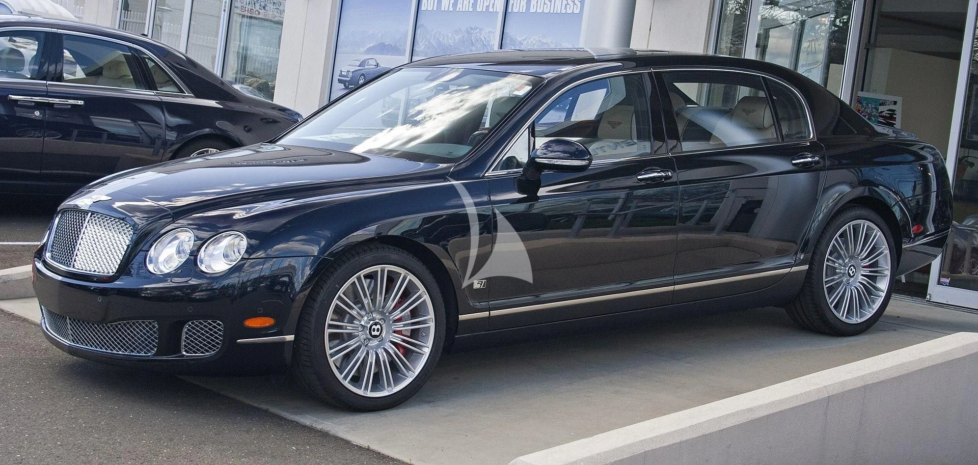 a black car parked in a parking lot aboard MANU V Yacht for Sale
