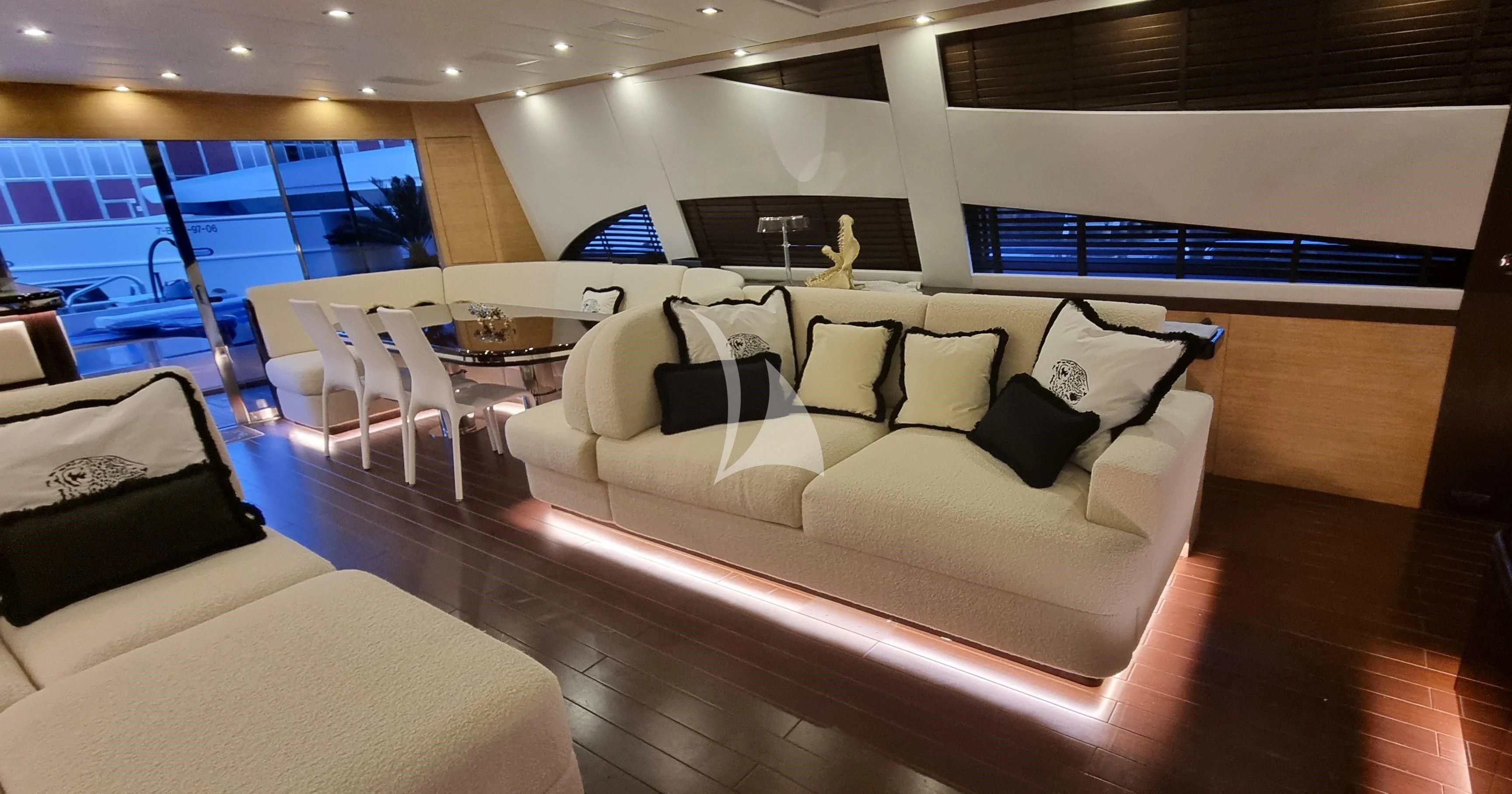 a large room with a couch and a table aboard MANU V Yacht for Sale