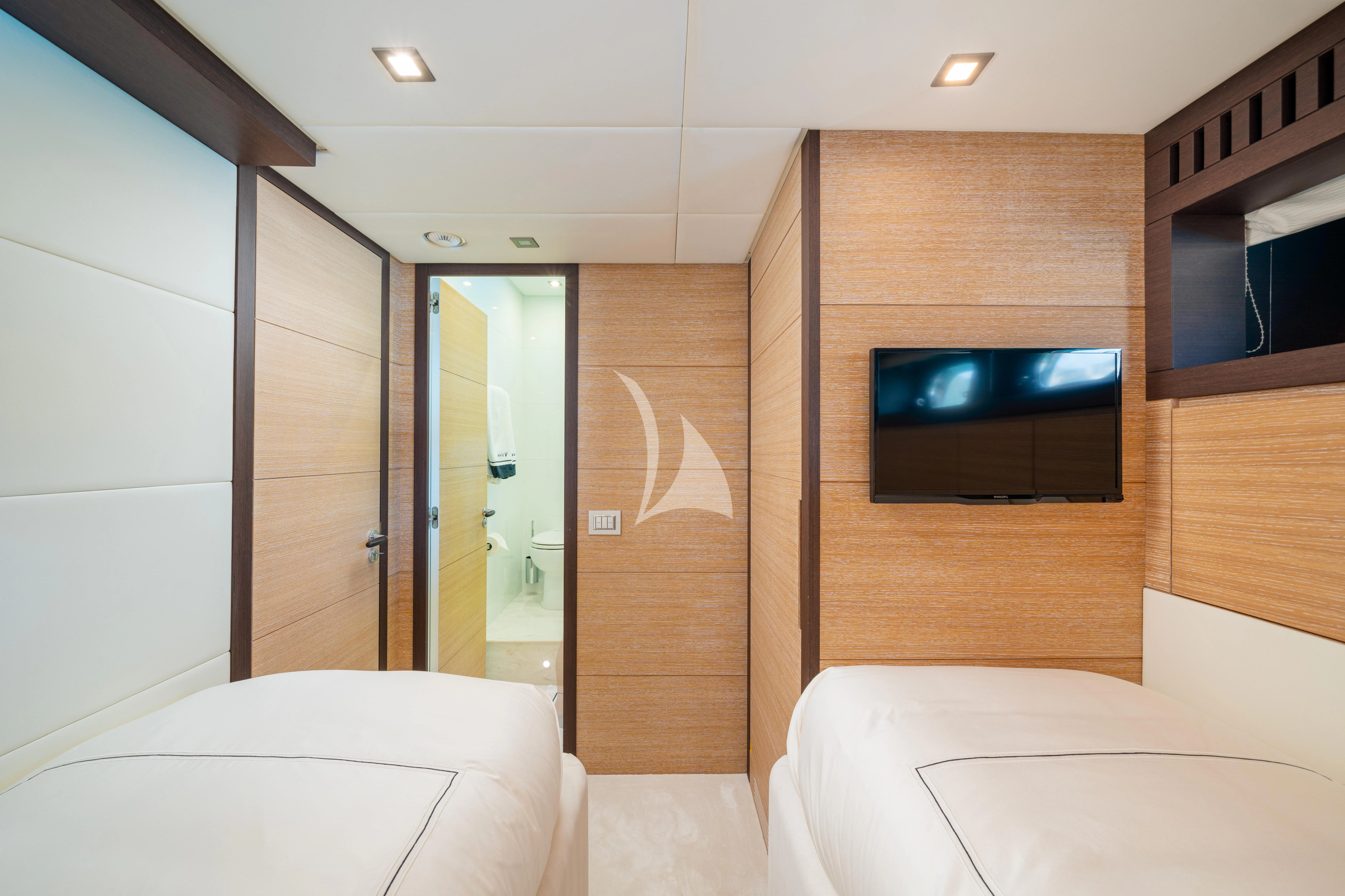 a room with a bed and a television aboard MANU V Yacht for Sale