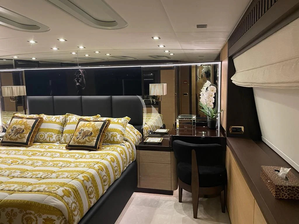 a bedroom with a bed and desk aboard MANU V Yacht for Sale