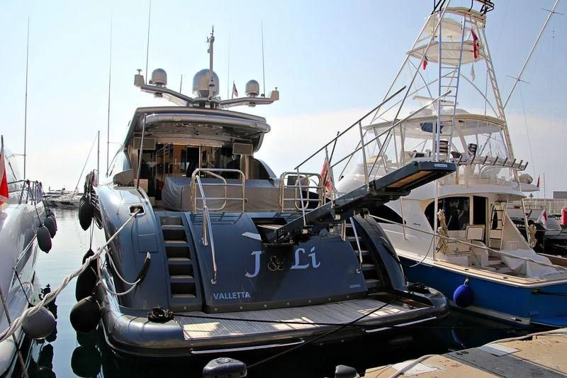 boats docked at a pier aboard MANU V Yacht for Sale