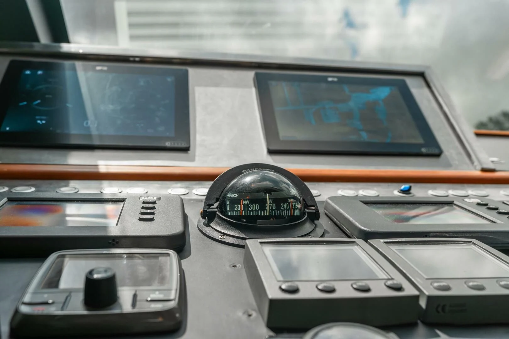 a desk with a computer and other electronics on it aboard BLUWATER Yacht for Sale