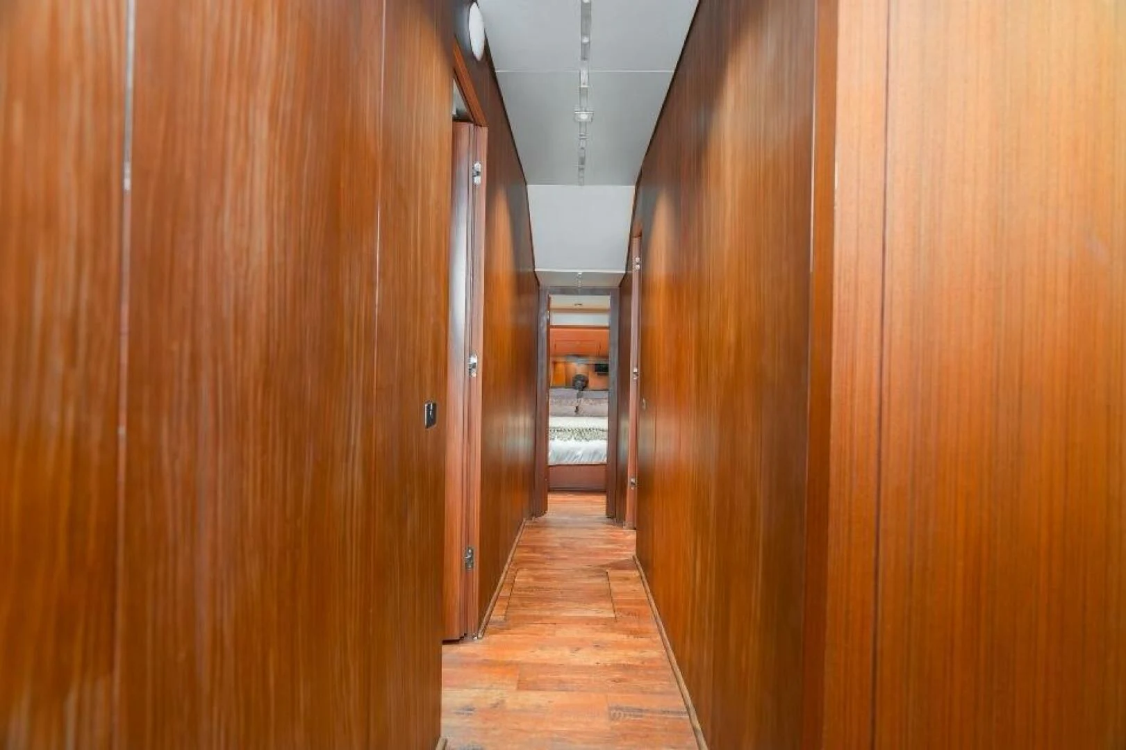 a hallway with wooden doors aboard BLUWATER Yacht for Sale