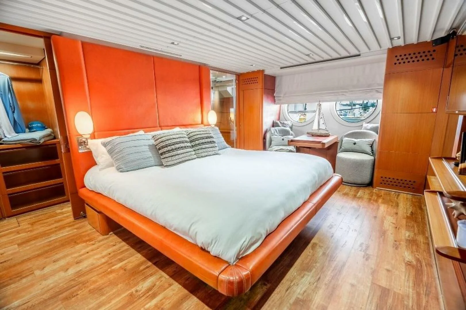 a bedroom with a bed and a chair aboard BLUWATER Yacht for Sale