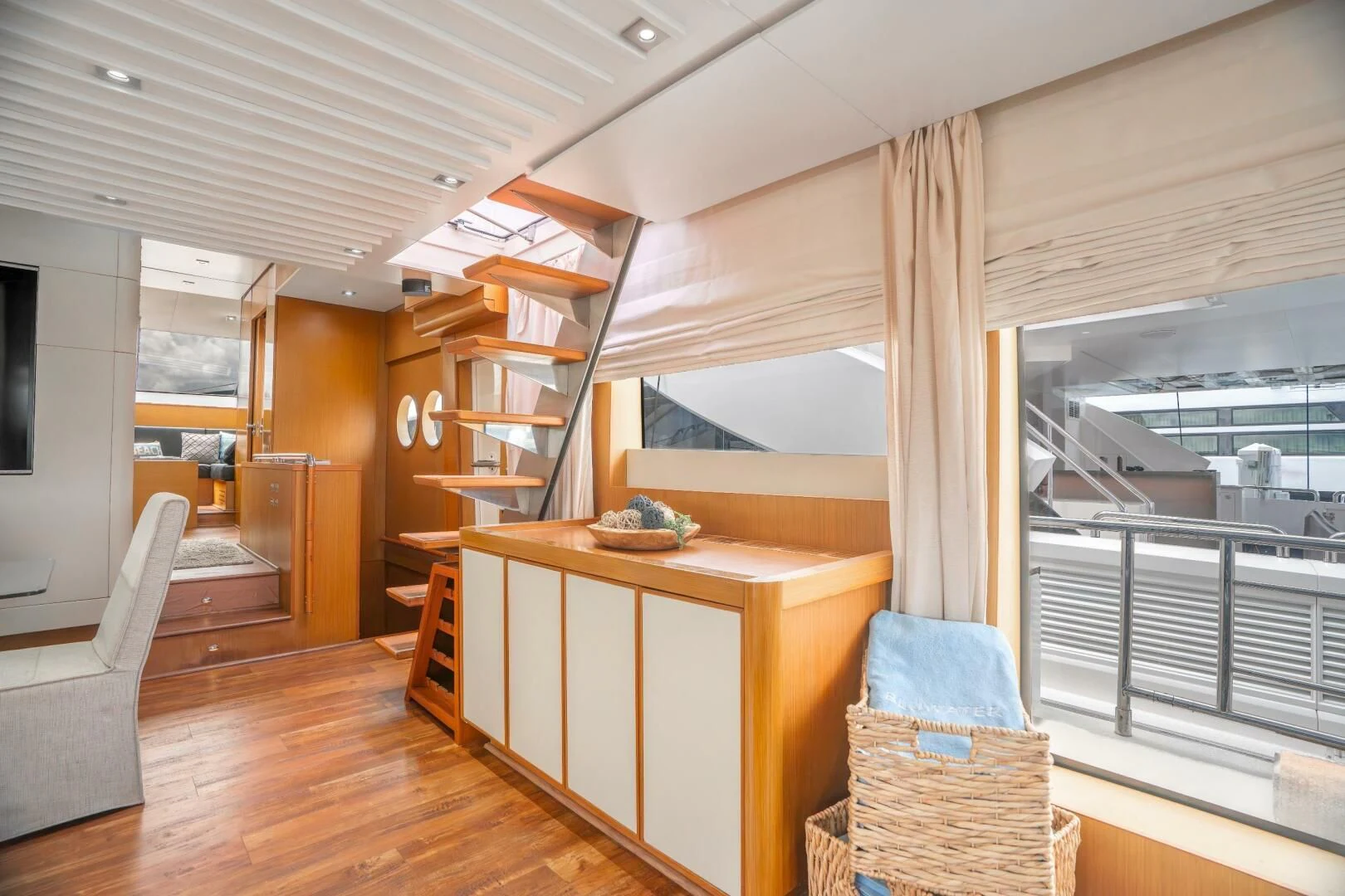 a room with a wood floor and a wood desk and a window aboard BLUWATER Yacht for Sale