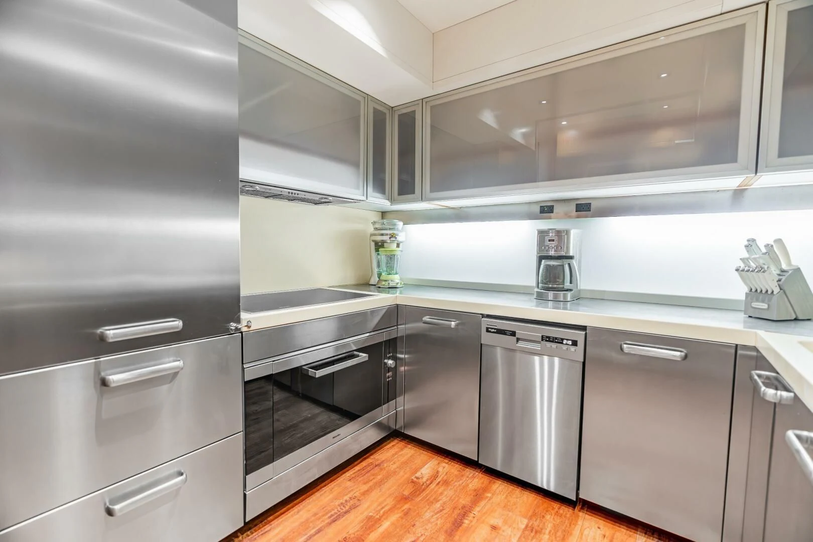a kitchen with black appliances aboard BLUWATER Yacht for Sale