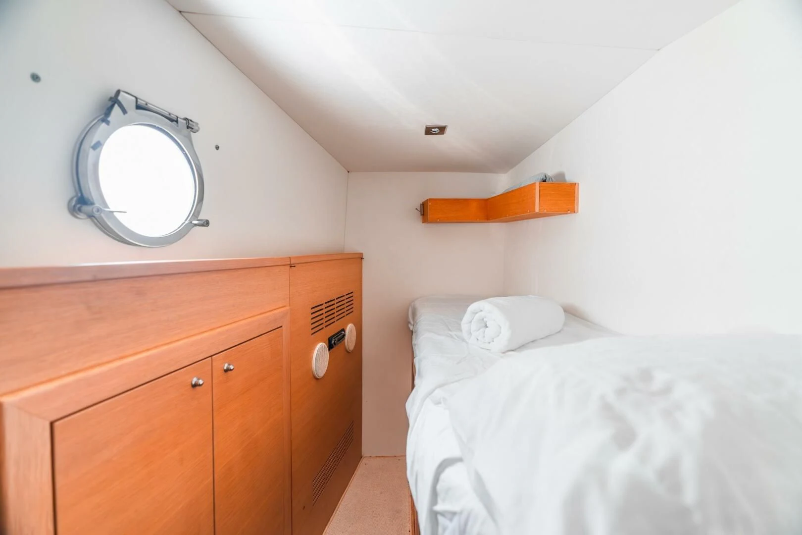 a bedroom with a bed and a mirror aboard BLUWATER Yacht for Sale