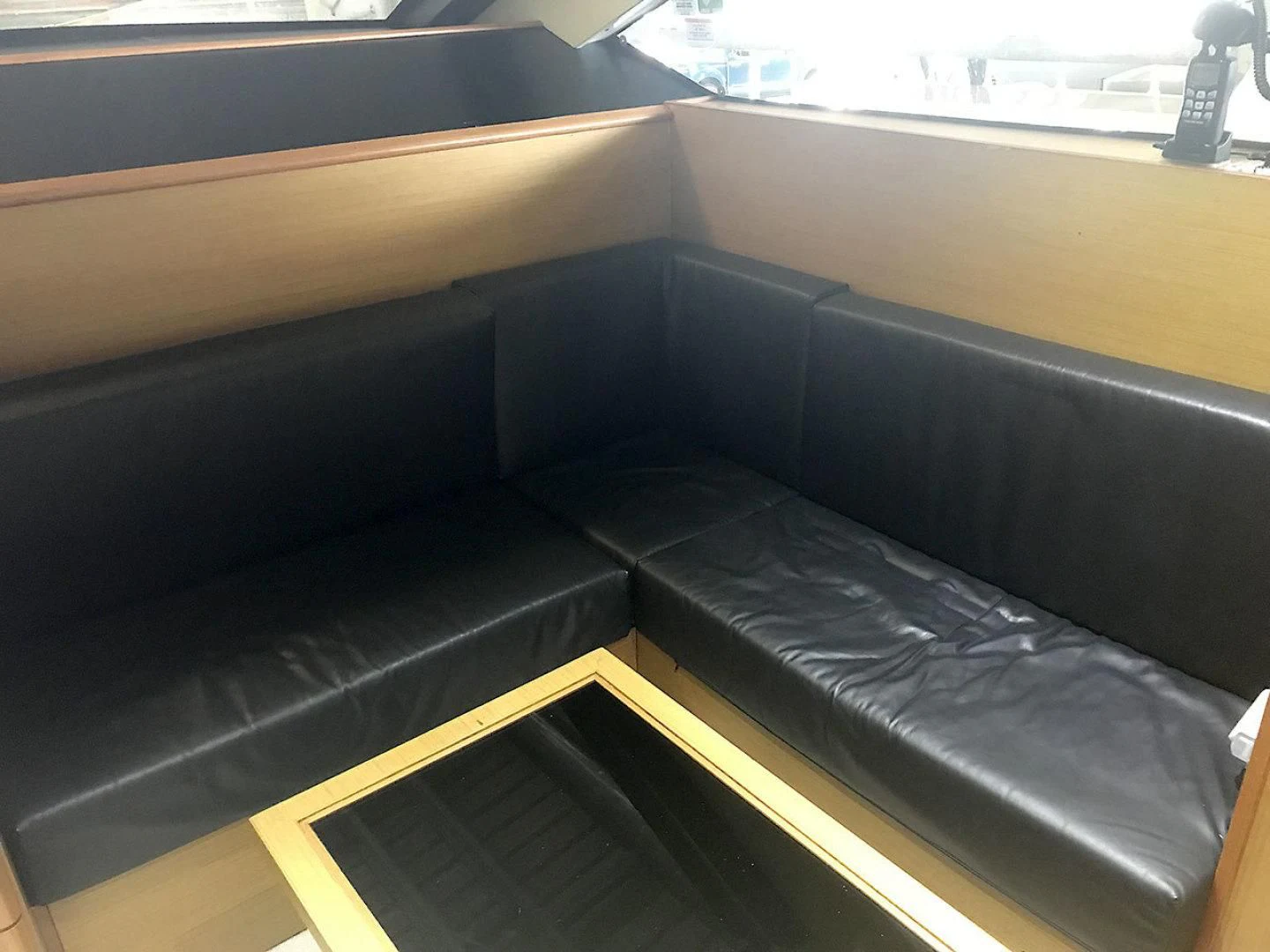 a black couch in a room aboard BLUWATER Yacht for Sale