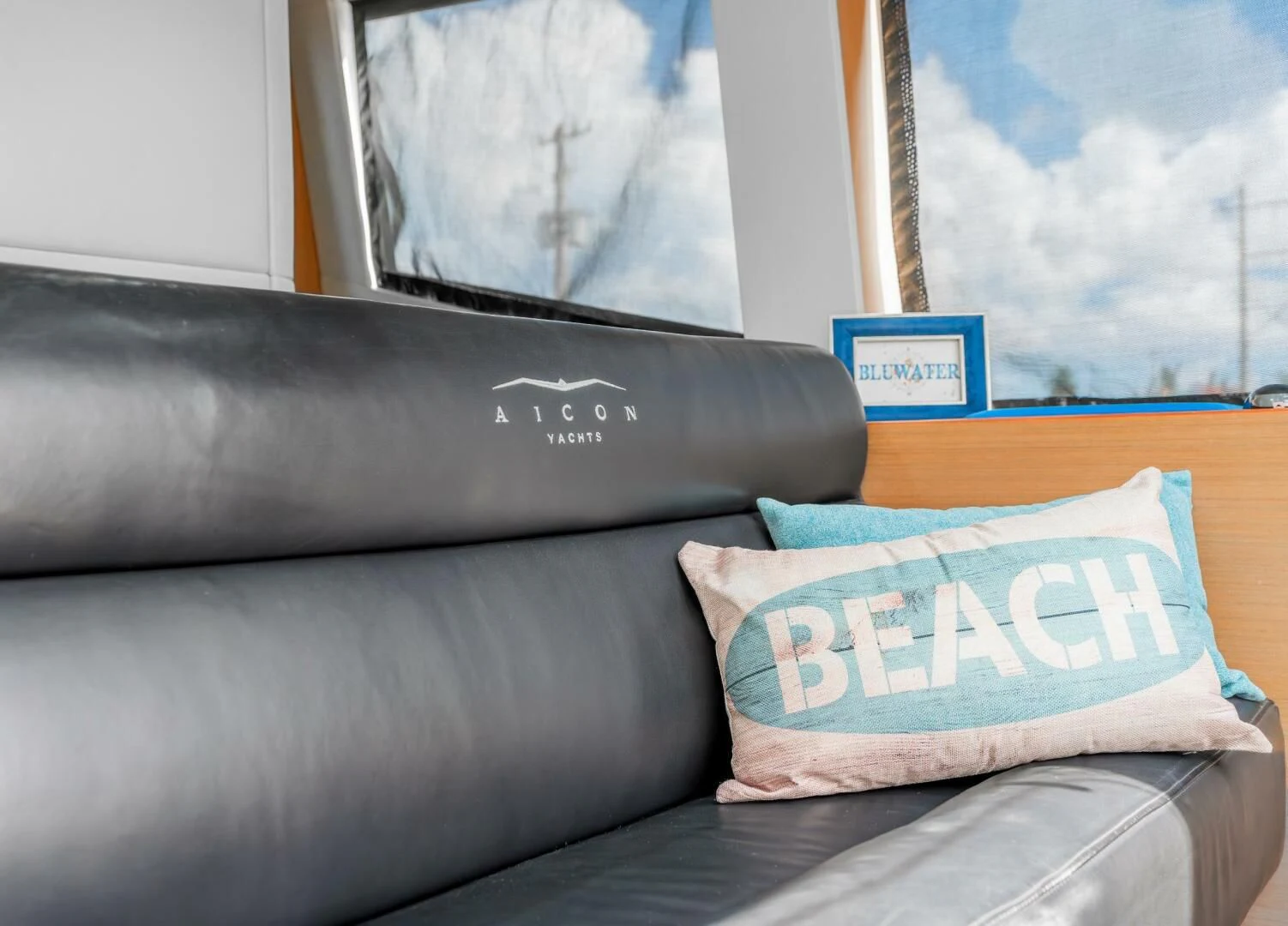 a couch with pillows aboard BLUWATER Yacht for Sale