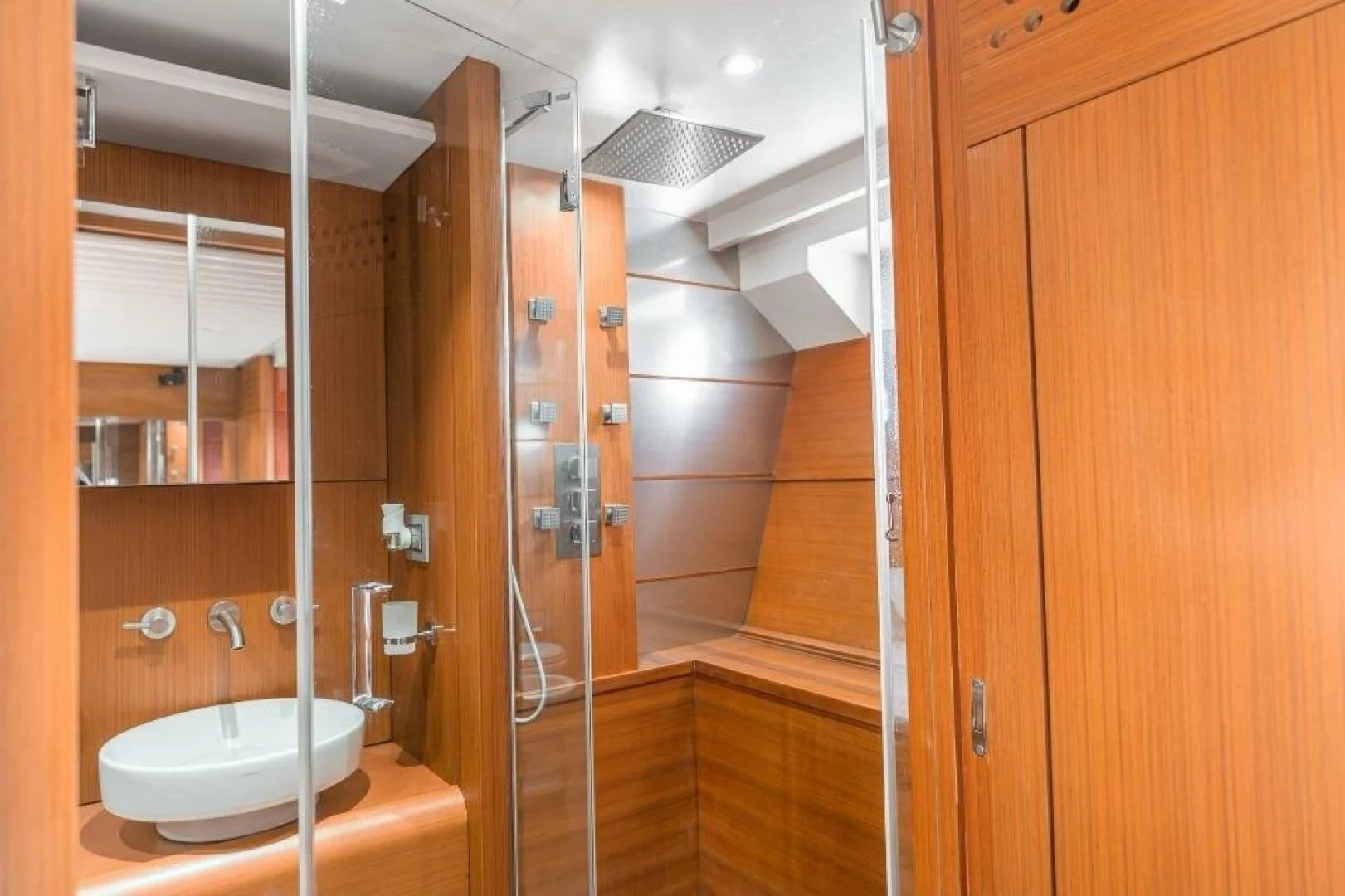 a bathroom with a glass shower aboard BLUWATER Yacht for Sale