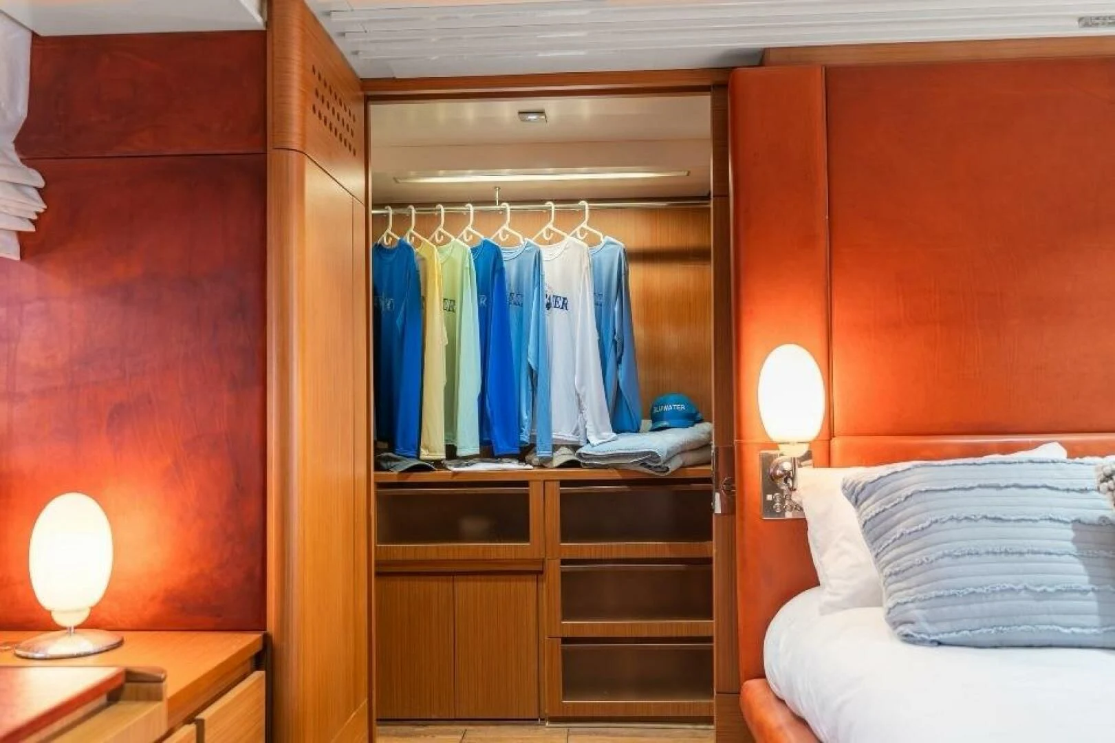 a closet with clothes on the wall aboard BLUWATER Yacht for Sale