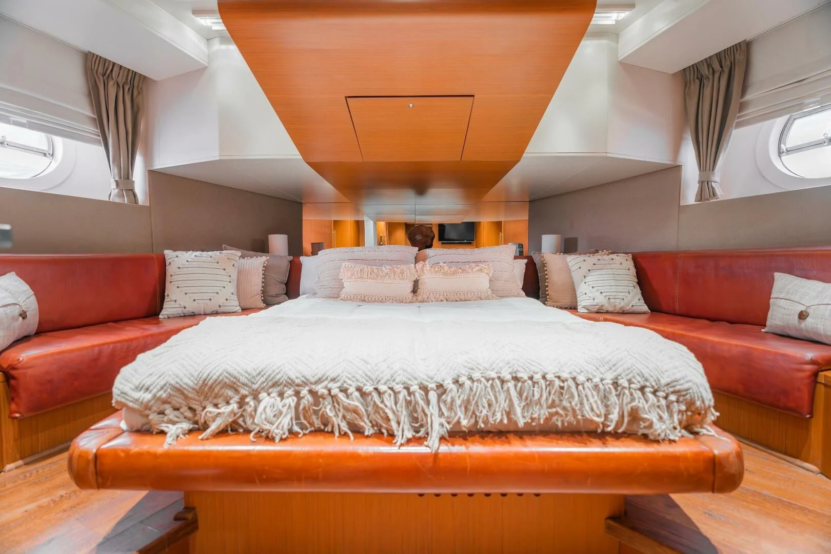 a bed with a red couch aboard BLUWATER Yacht for Sale